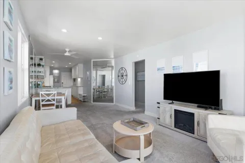 a kitchen with stainless steel appliances kitchen island granite countertop a refrigerator and a sink