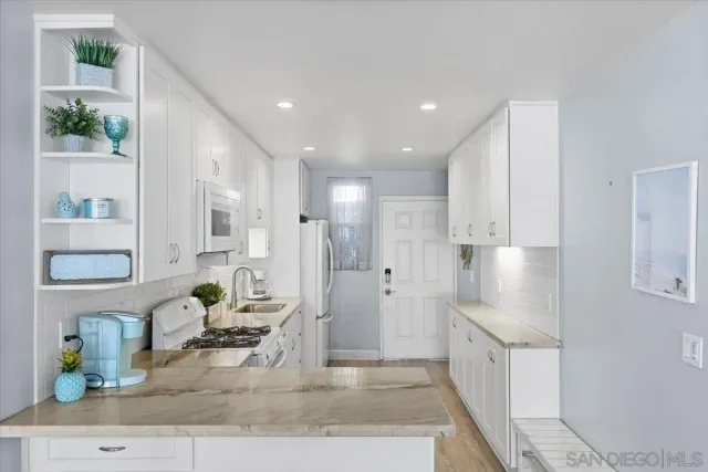 a bedroom with a bed and a lamp next to a window