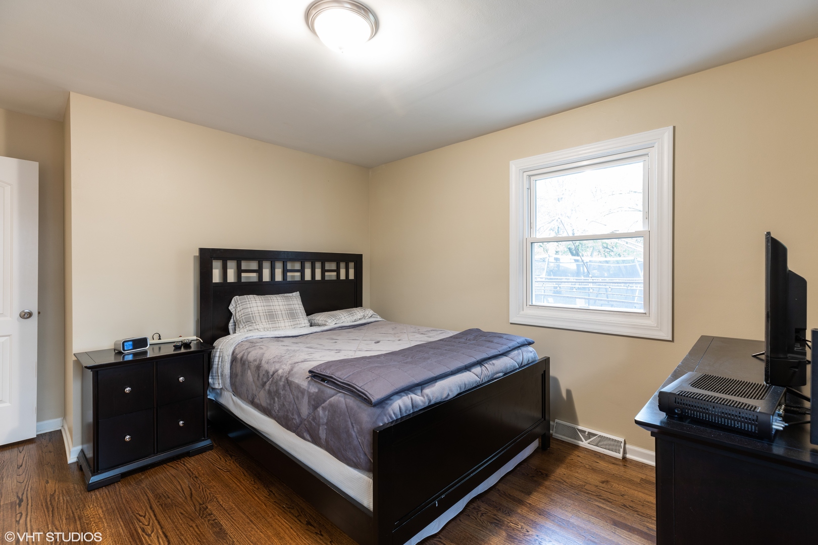 1329 Olive Road Homewood, IL 60430 - Photo 6 of 17 a bedroom with a bed and a flat screen tv