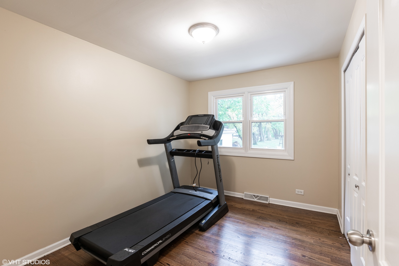 1329 Olive Road Homewood, IL 60430 - Photo 9 of 17 a room with gym equipment on wooden floor