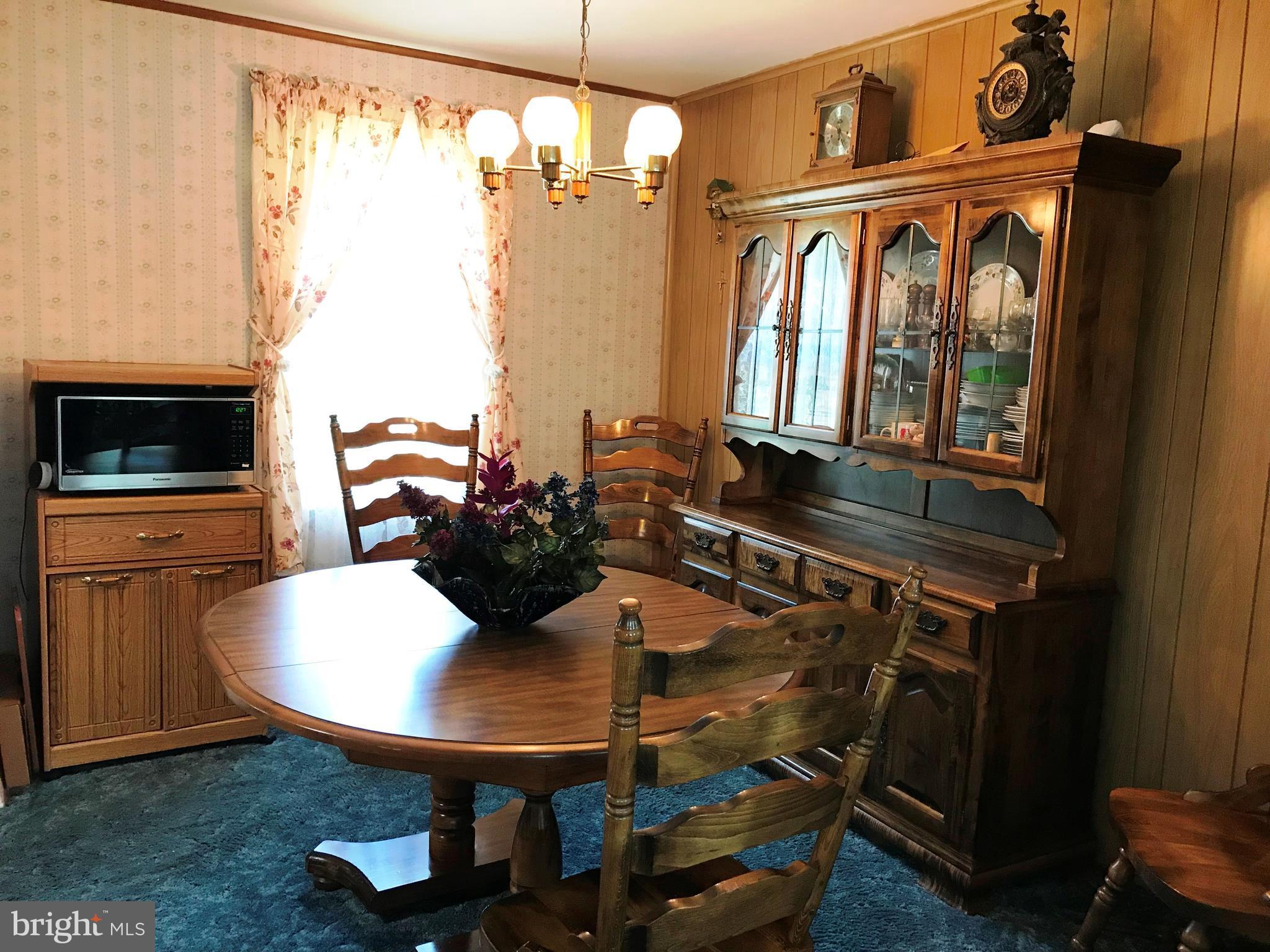9017 Tammy Road Baltimore, MD 21236 - Photo 11 of 23 a view of a dining room with furniture and window