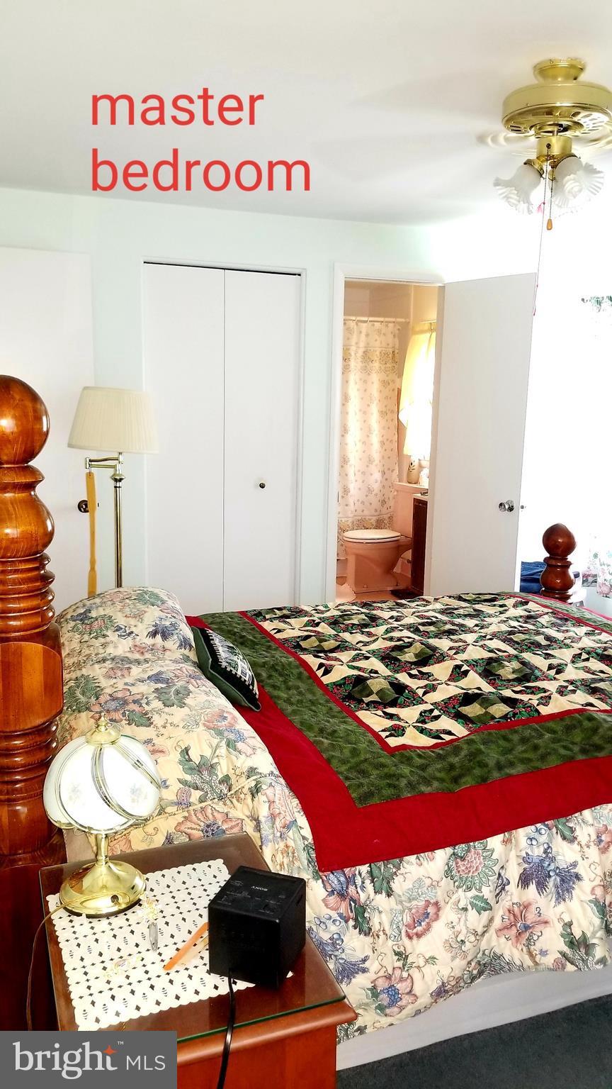 9017 Tammy Road Baltimore, MD 21236 - Photo 17 of 23 a bedroom with a bed and a chandelier