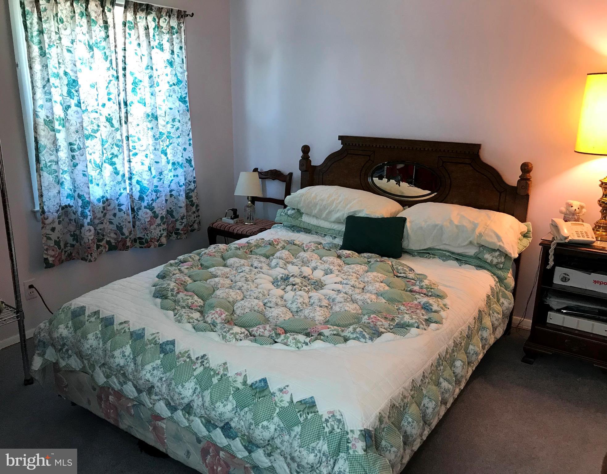 9017 Tammy Road Baltimore, MD 21236 - Photo 18 of 23 a bed sitting in a bedroom next to a window