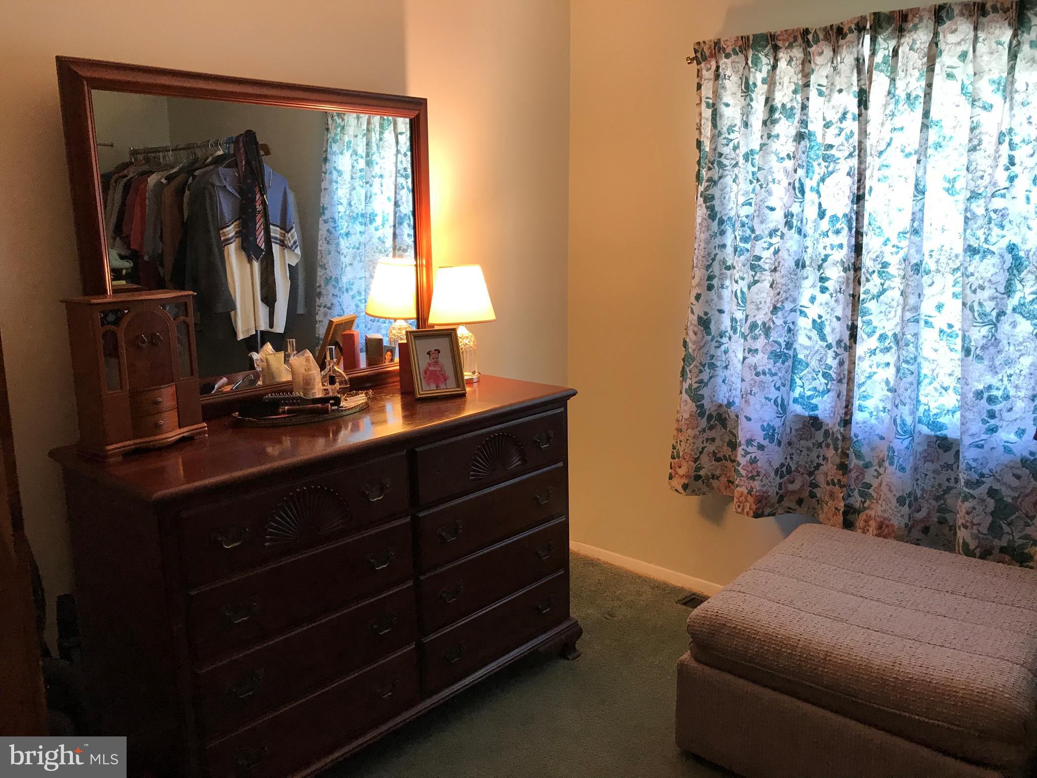 9017 Tammy Road Baltimore, MD 21236 - Photo 20 of 23 a room with a bed and a mirror