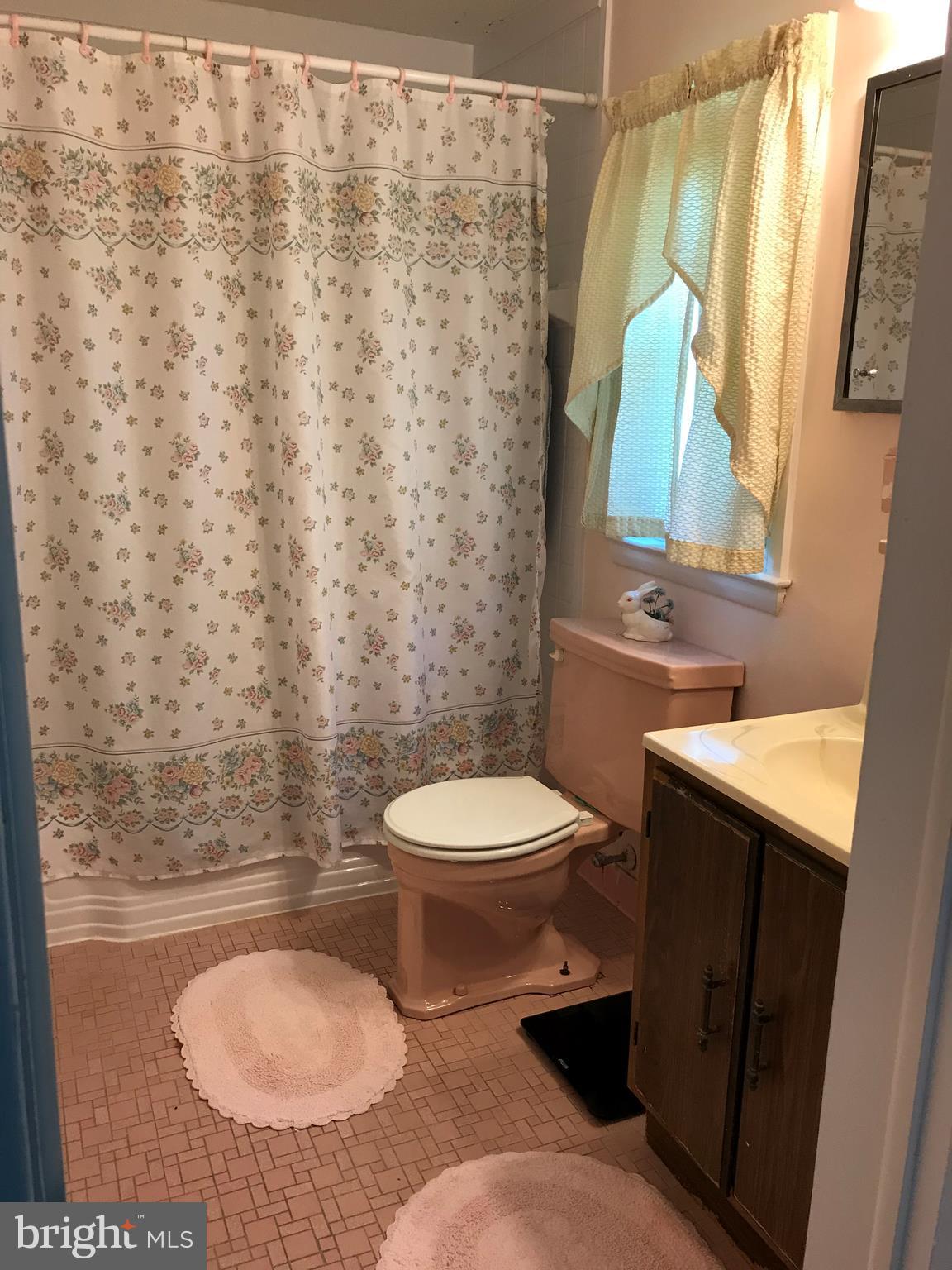 9017 Tammy Road Baltimore, MD 21236 - Photo 21 of 23 a bathroom with a toilet a sink and a mirror