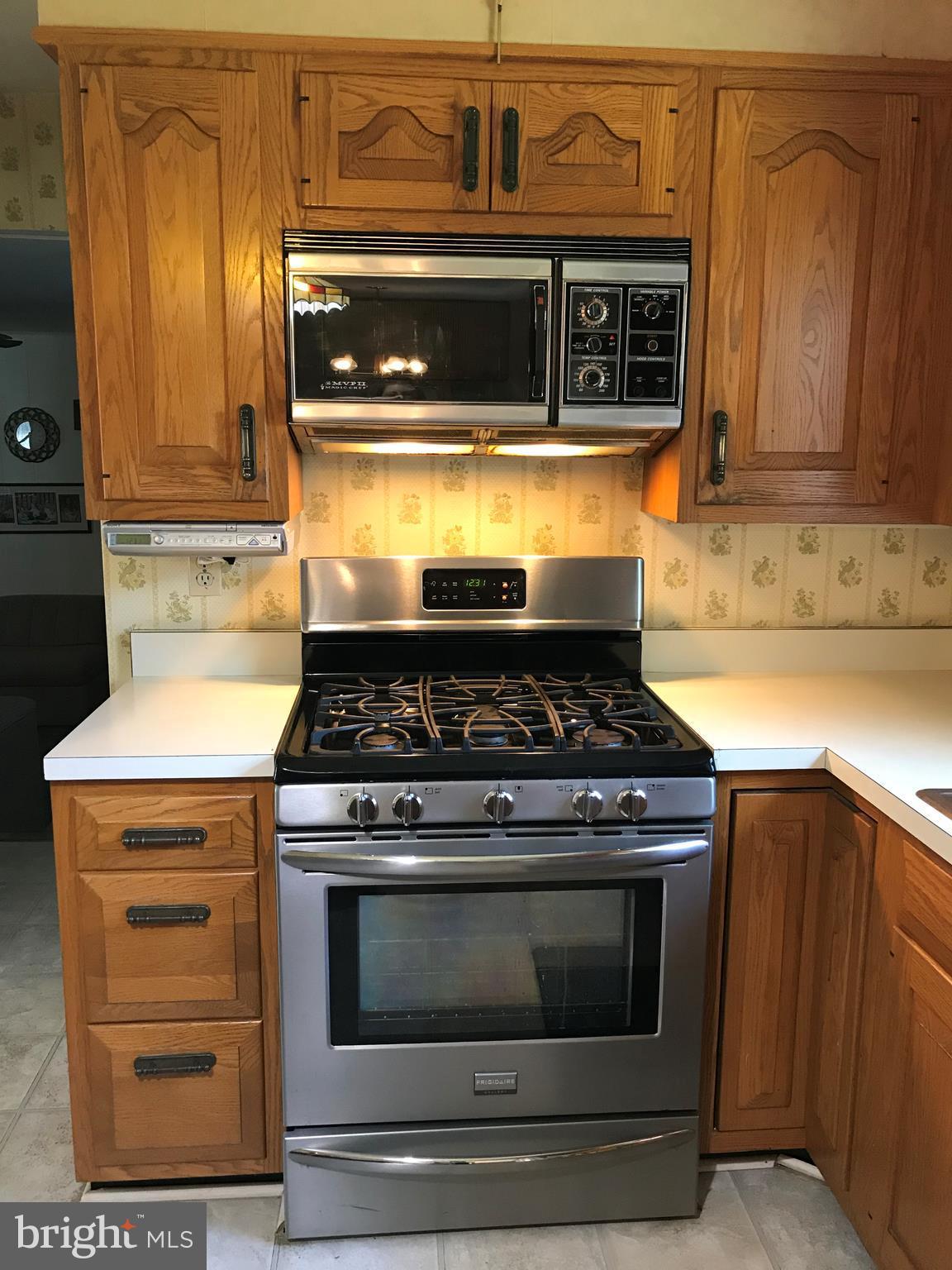 9017 Tammy Road Baltimore, MD 21236 - Photo 7 of 23 a stove top oven sitting inside of a kitchen and granite counter tops