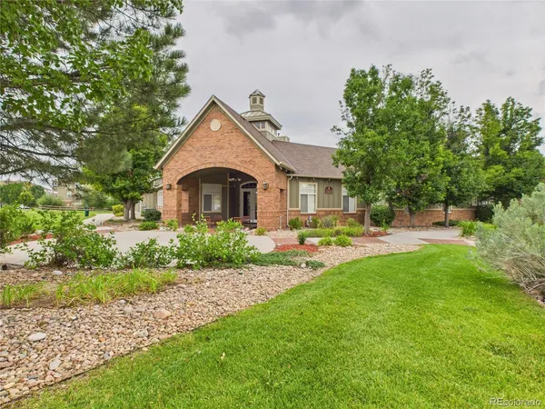 a front view of a house with yard and green space