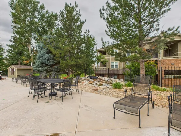 a view of a patio with a table and chairs and potted plants