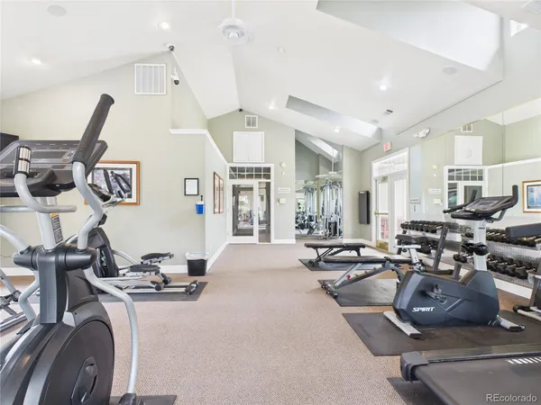 a living room with lots of furniture and gym equipment