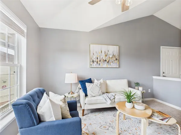 a living room with furniture and painting on the wall