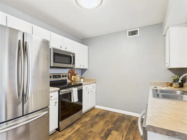 a kitchen with a refrigerator stove and sink