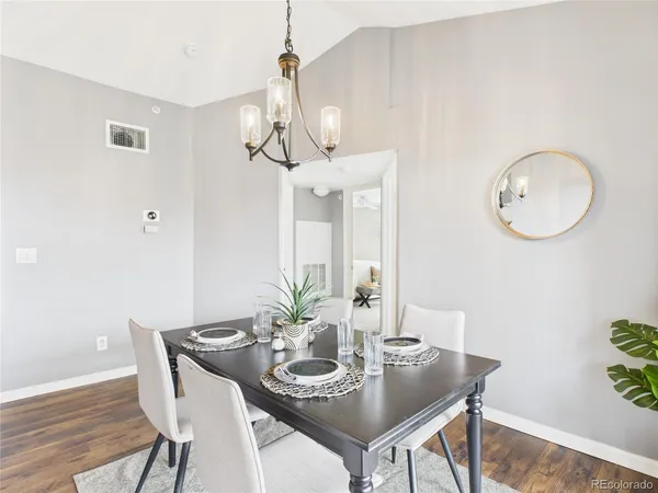a view of a dining room with furniture and chandelier