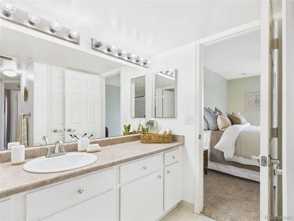 a en suite bathroom with double sink and a mirror