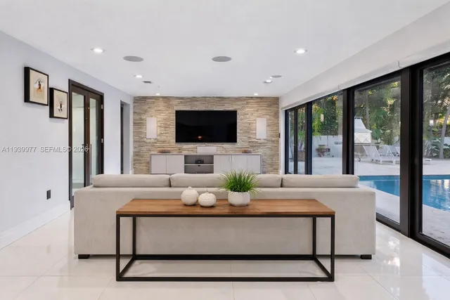 a living room with fireplace furniture and a flat screen tv