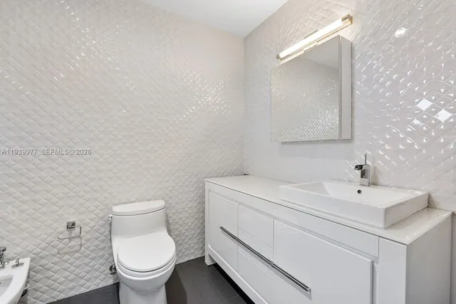 a bathroom with a toilet sink and shower