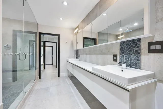 a bathroom with a glass shower door