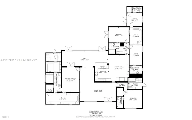 a large bedroom with bed mirror and window