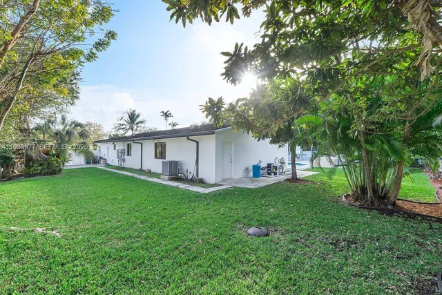 a front view of house with a garden