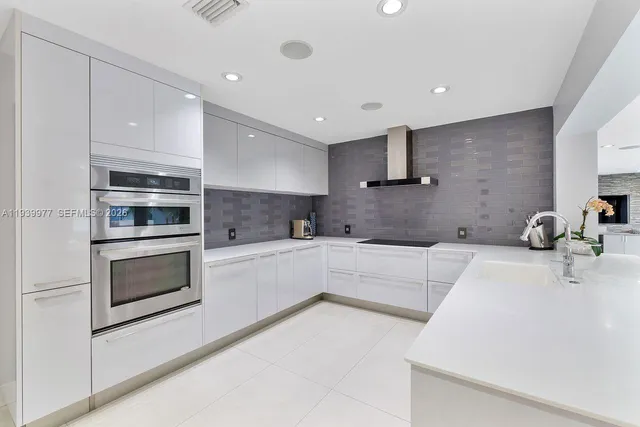 a kitchen with stainless steel appliances and white cabinets
