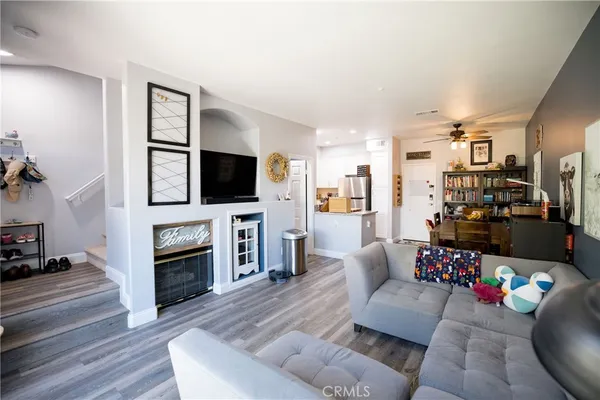 a bedroom with a bed and painting on the wall