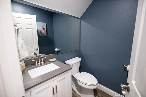 a bedroom with a bed a wall painting and a book shelf