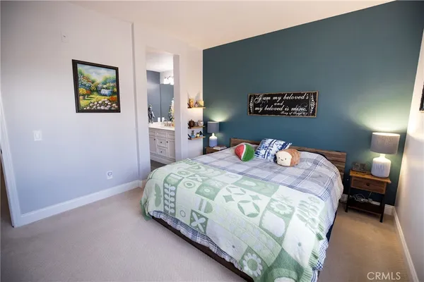 a bedroom with a bed and a wall painting