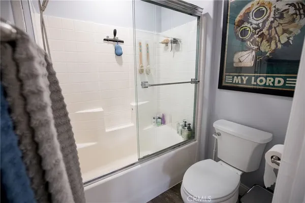 a bathroom with a toilet a sink and a large mirror