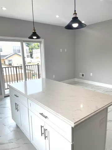 a kitchen with stainless steel appliances a white roof top oven a sink and a chandelier
