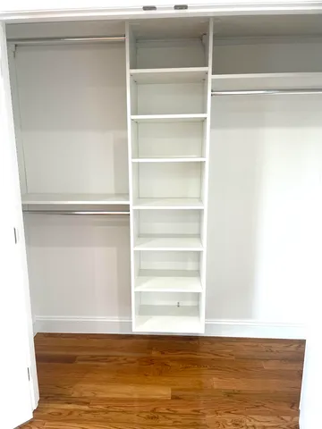 a view of a room with wooden floor