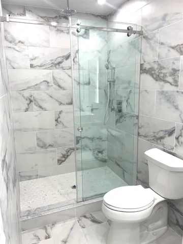 a bathroom with a toilet and a shower