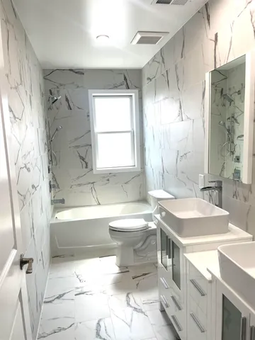 a bathroom with a sink toilet tub and shower