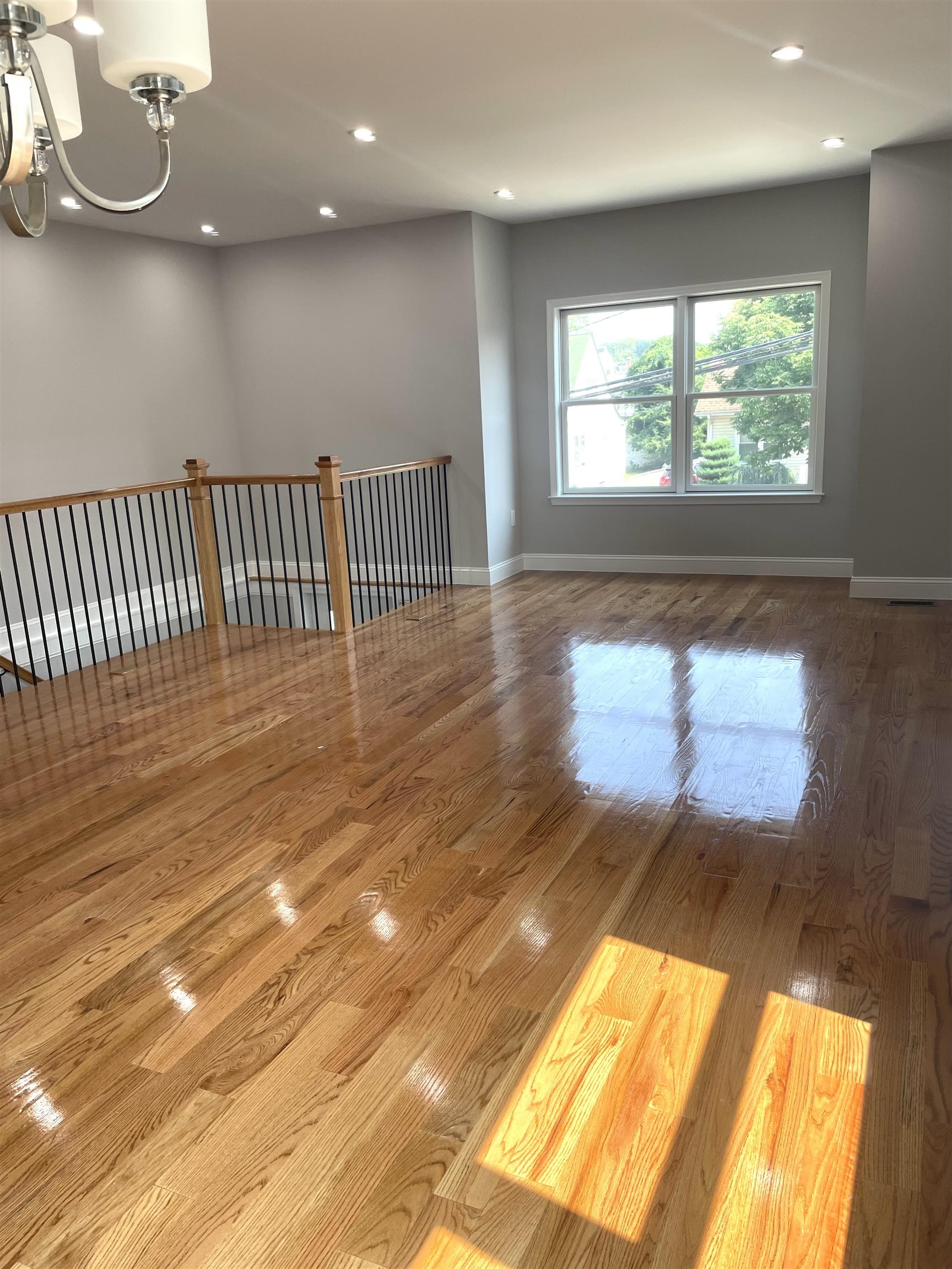 761 B 4th Street, Unit B Secaucus, NJ 07094 - Photo 4 of 34 a view of an empty room with wooden floor and a window
