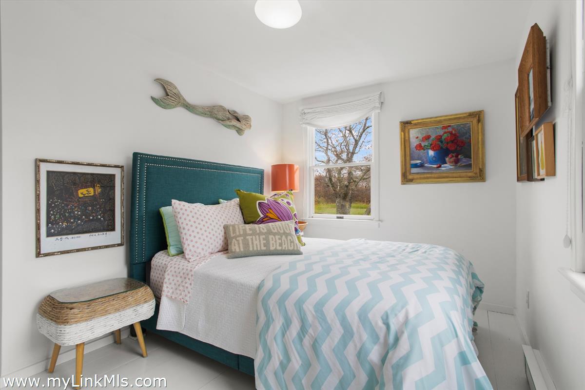 13 Parson Lane Nantucket, MA 02554 - Photo 37 of 44 a bedroom with a bed and a painting on the wall