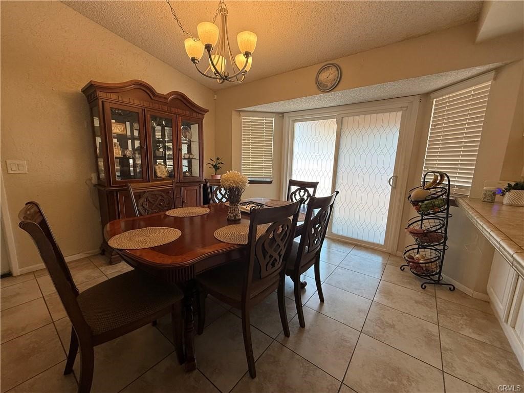 21275 Pocomoke Road Apple Valley, CA 92308 - Photo 12 of 40 a view of a dining room with furniture and chandelier