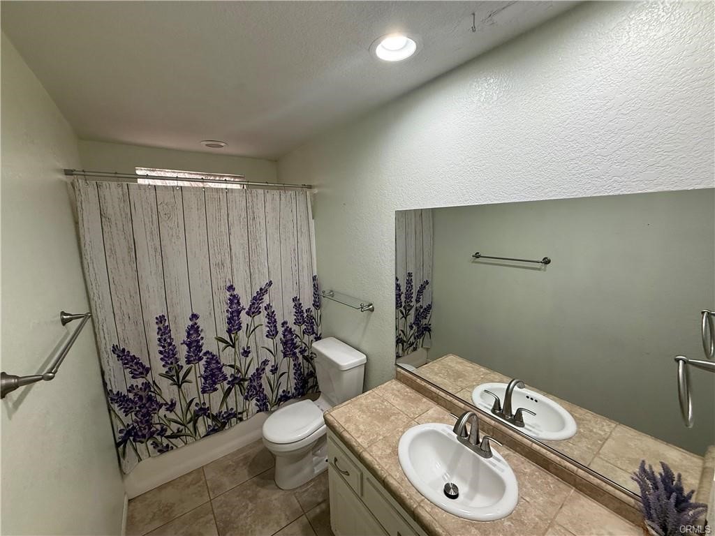 21275 Pocomoke Road Apple Valley, CA 92308 - Photo 20 of 40 a bathroom with a sink a toilet and mirror