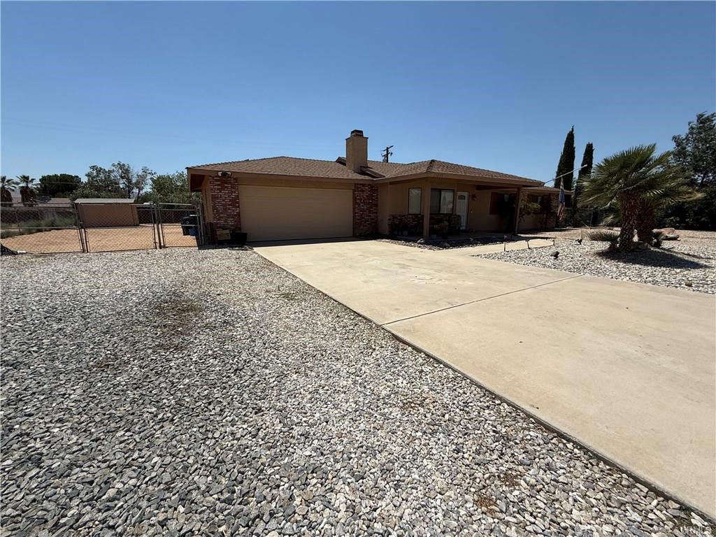 21275 Pocomoke Road Apple Valley, CA 92308 - Photo 2 of 40 a front view of a house with a yard