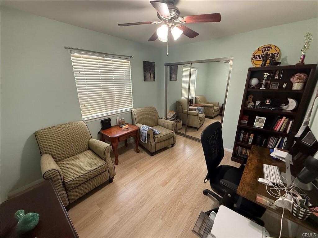 21275 Pocomoke Road Apple Valley, CA 92308 - Photo 21 of 40 a living room with furniture a ceiling fan and a window