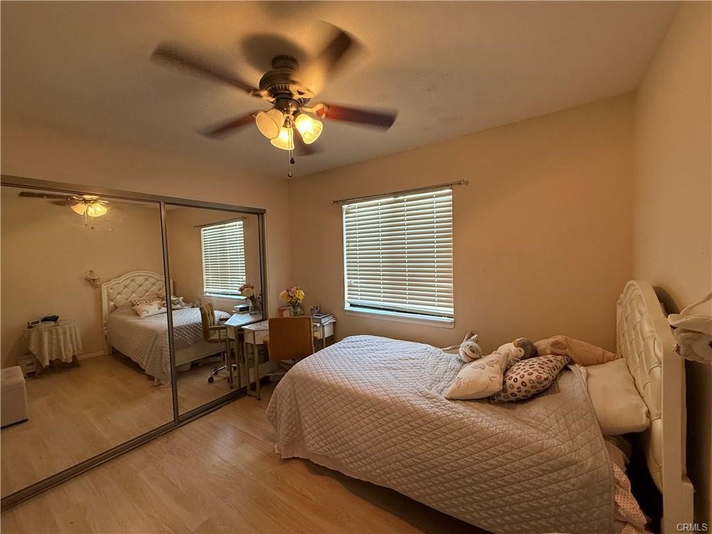 21275 Pocomoke Road Apple Valley, CA 92308 - Photo 23 of 40 a bedroom with a bed and a chandelier