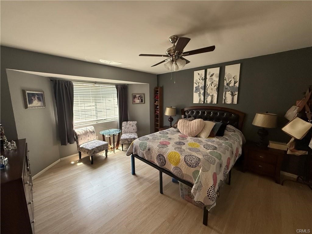21275 Pocomoke Road Apple Valley, CA 92308 - Photo 26 of 40 a bedroom with a bed and wooden floor