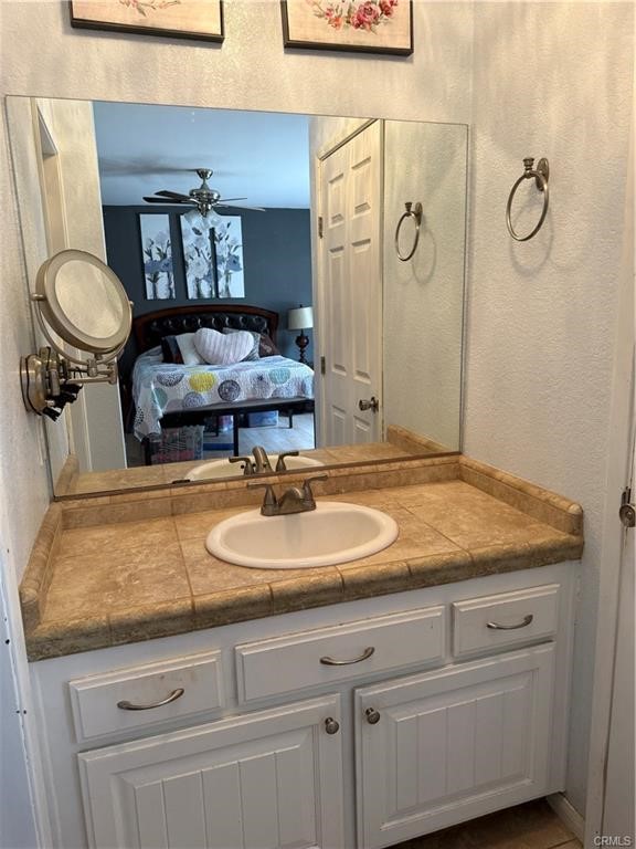 21275 Pocomoke Road Apple Valley, CA 92308 - Photo 32 of 40 a bathroom with a granite countertop sink and a mirror