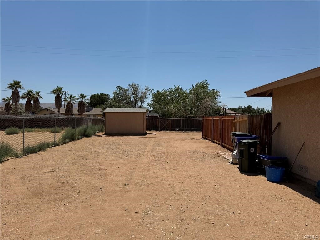21275 Pocomoke Road Apple Valley, CA 92308 - Photo 4 of 40 a bedroom with a bed and a dresser