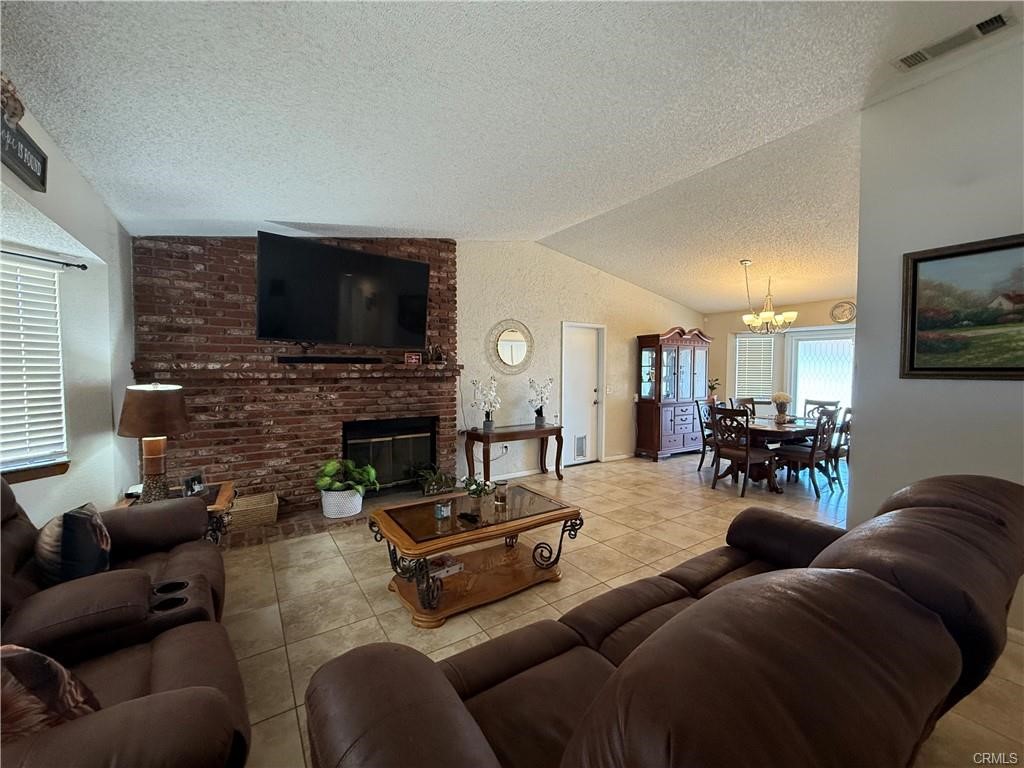 21275 Pocomoke Road Apple Valley, CA 92308 - Photo 8 of 40 a living room with fireplace furniture and a flat screen tv