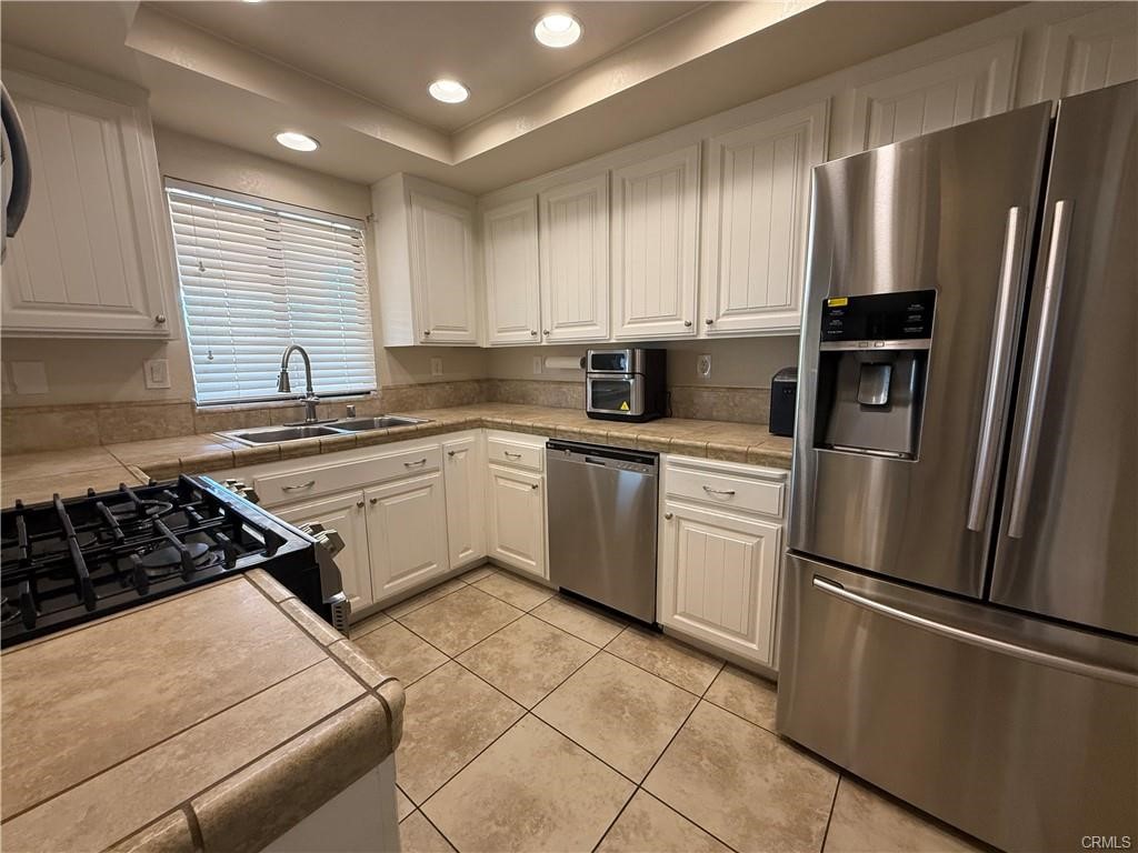 21275 Pocomoke Road Apple Valley, CA 92308 - Photo 9 of 40 a kitchen with a refrigerator sink and microwave