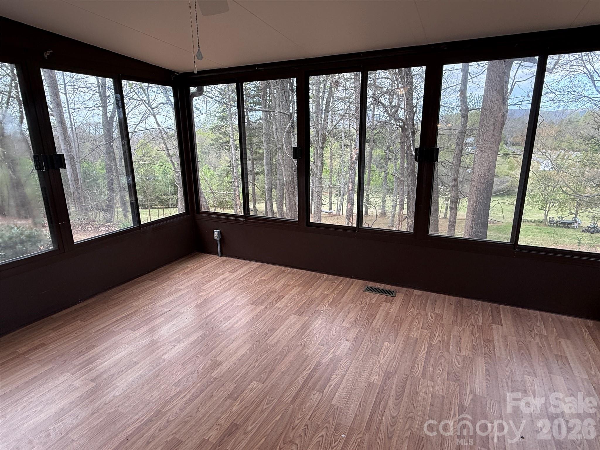7686 Shoupes Grove Church Road Hickory, NC 28602 - Photo 15 of 36 a view of an empty room with a window and wooden floor