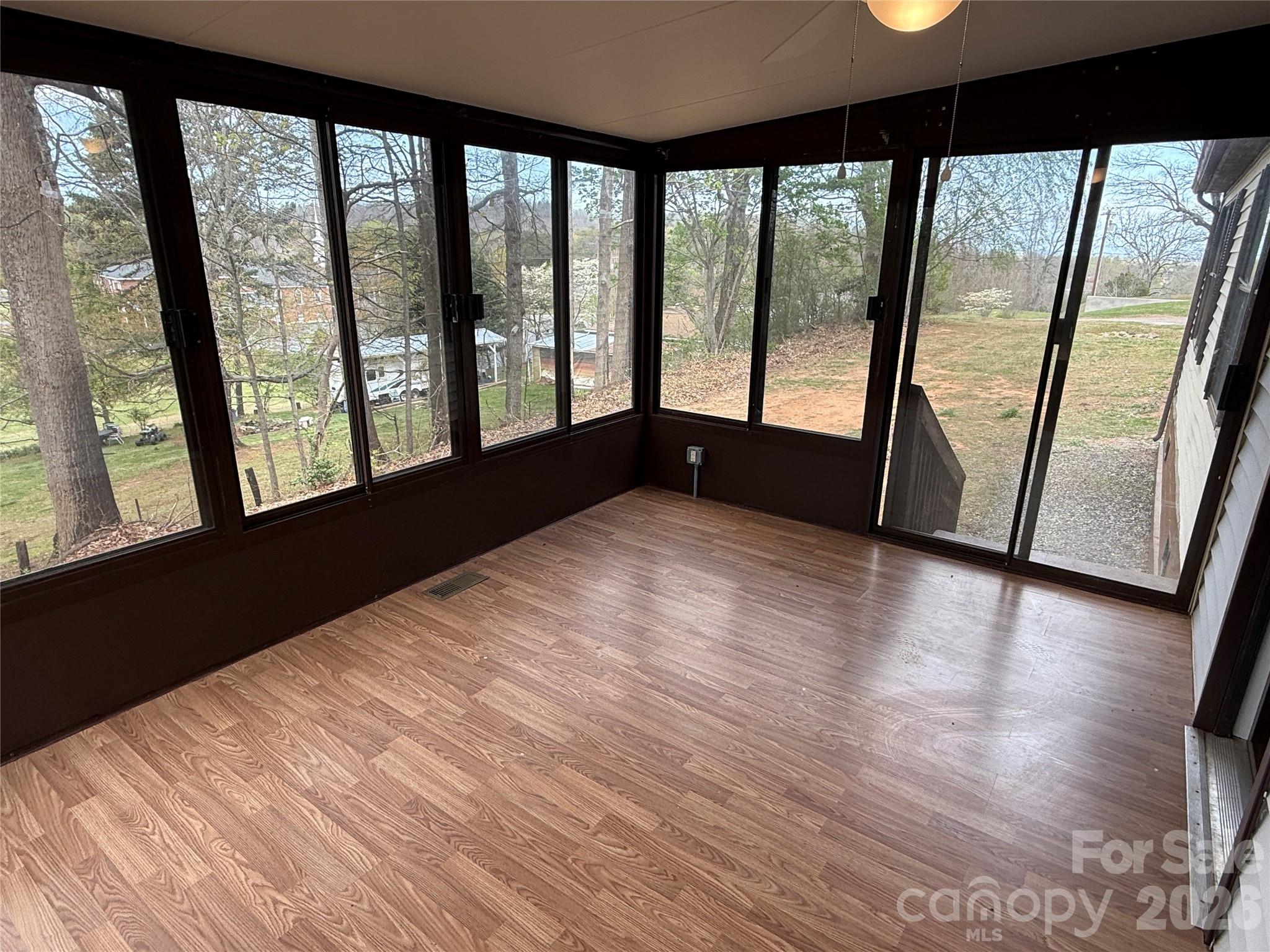 7686 Shoupes Grove Church Road Hickory, NC 28602 - Photo 16 of 36 a view of an empty room with wooden floor and a window