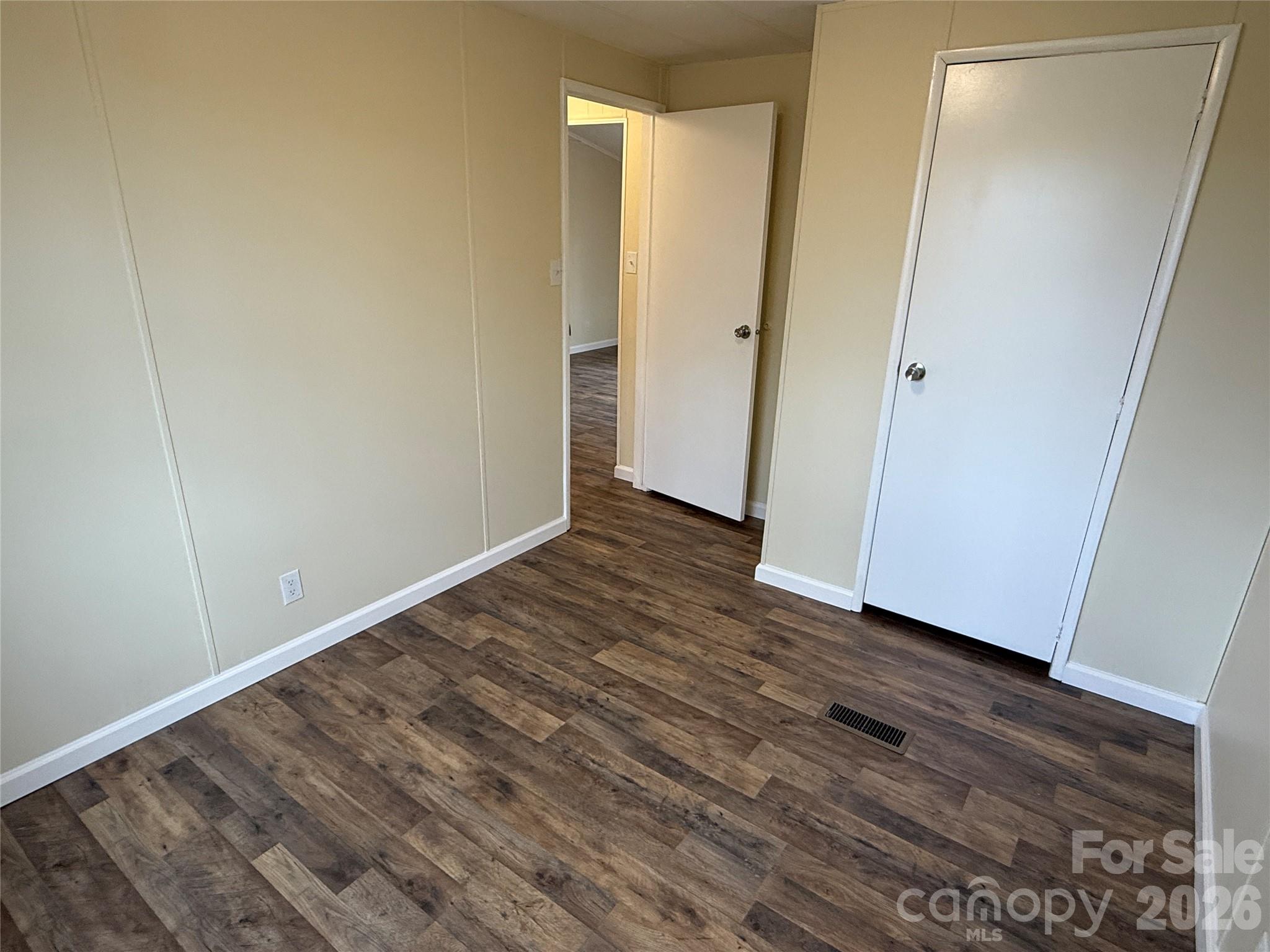 7686 Shoupes Grove Church Road Hickory, NC 28602 - Photo 18 of 36 a view of an empty room with wooden floor and closet
