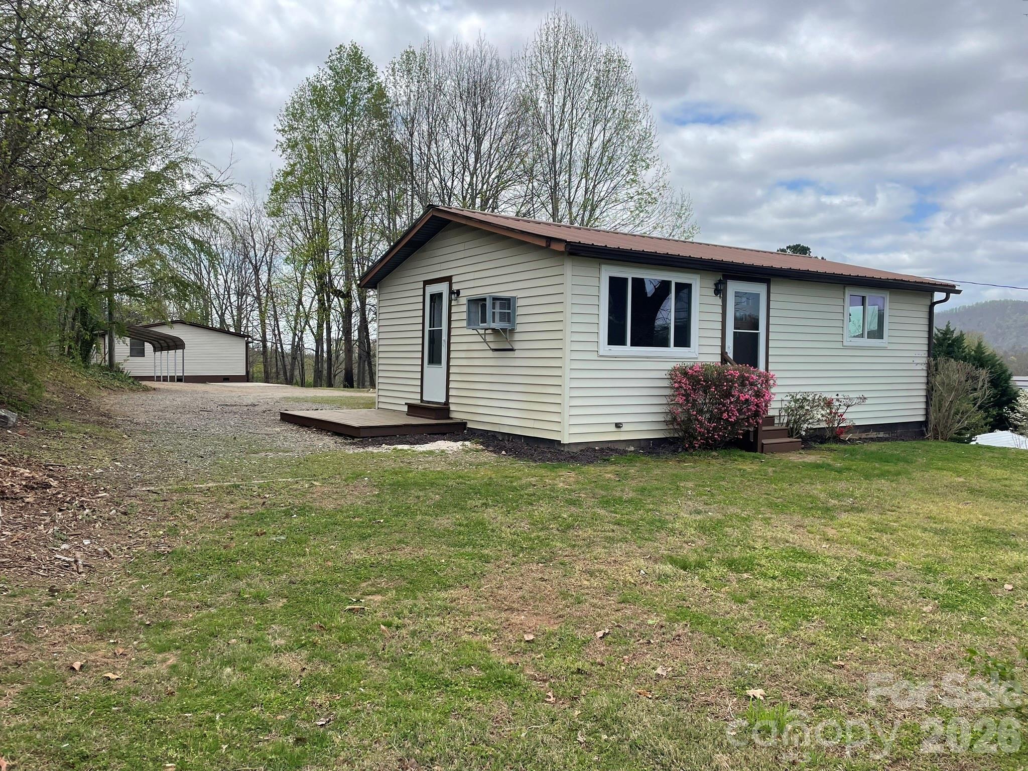 7686 Shoupes Grove Church Road Hickory, NC 28602 - Photo 22 of 36 a front view of house with yard and trees around