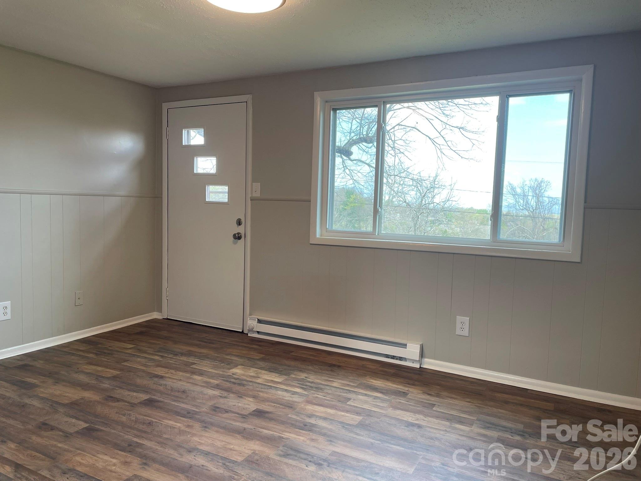7686 Shoupes Grove Church Road Hickory, NC 28602 - Photo 24 of 36 an empty room with wooden floor and windows