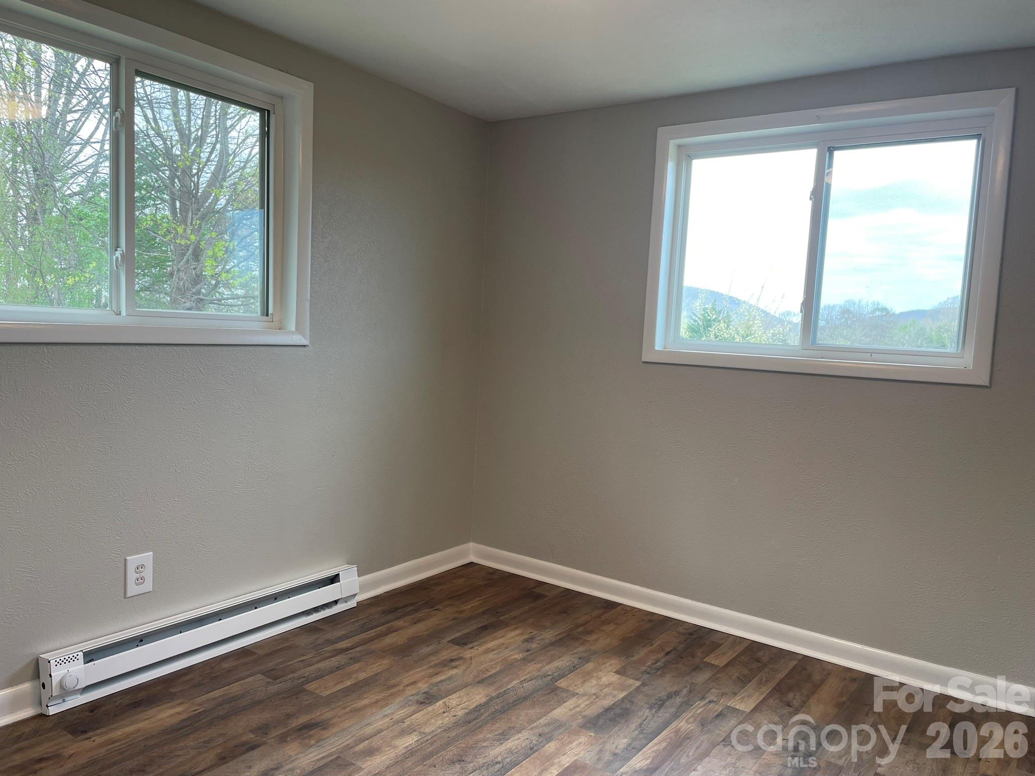 7686 Shoupes Grove Church Road Hickory, NC 28602 - Photo 31 of 36 a view of an empty room with wooden floor and a window
