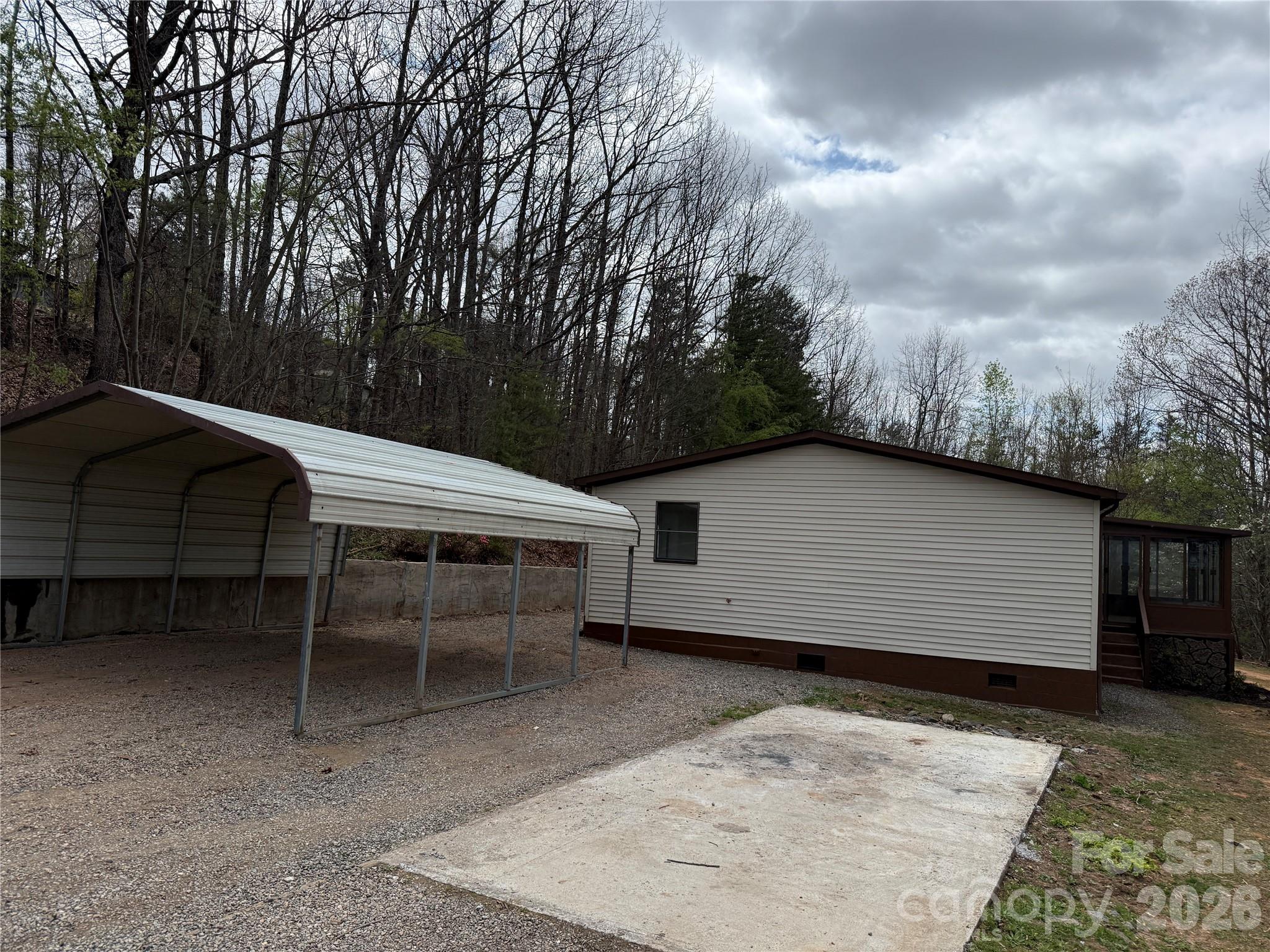 7686 Shoupes Grove Church Road Hickory, NC 28602 - Photo 5 of 36 a view of a patio with table and chairs with wooden fence and plants